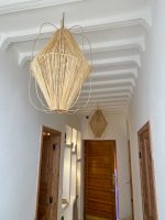 Diamond raffia pendant light with sculptural handwoven cage design