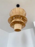 Handmade tiered raffia pendant light with layered sculptural design
