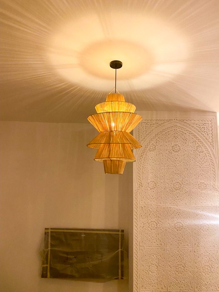 Handmade tiered raffia pendant light with layered sculptural design