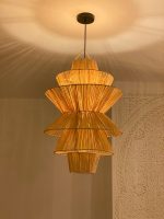 Handmade tiered raffia pendant light with layered sculptural design
