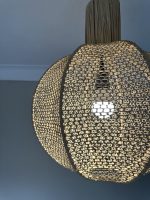 Round raffia pendant light handmade in Morocco with woven globe shape