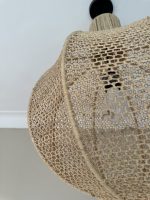 Round raffia pendant light handmade in Morocco with woven globe shape