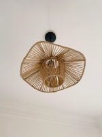 Sculptural raffia pendant light with open radial flared shade