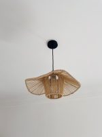 Sculptural raffia pendant light with open radial flared shade
