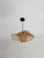Sculptural raffia pendant light with open radial flared shade