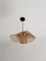 Sculptural raffia pendant light with open radial flared shade