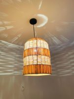 Tiered raffia pendant light with handwoven bell shaped shade