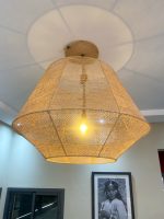 Handmade raffia pendant light with wide flared woven shape