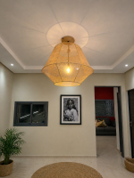 Handmade raffia pendant light with wide flared woven shape