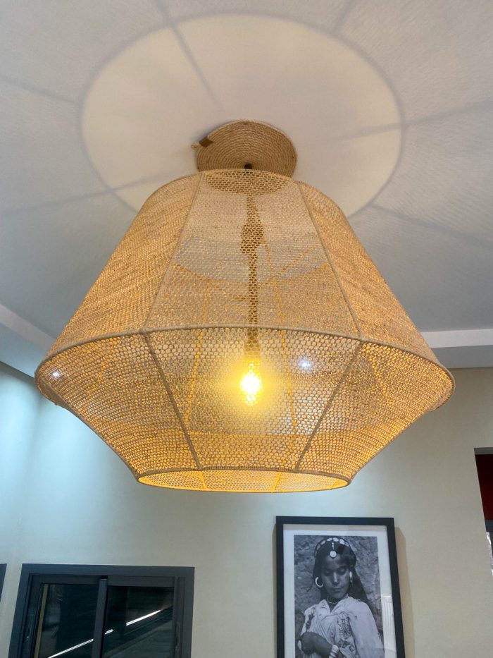 Handmade raffia pendant light with wide flared woven shape