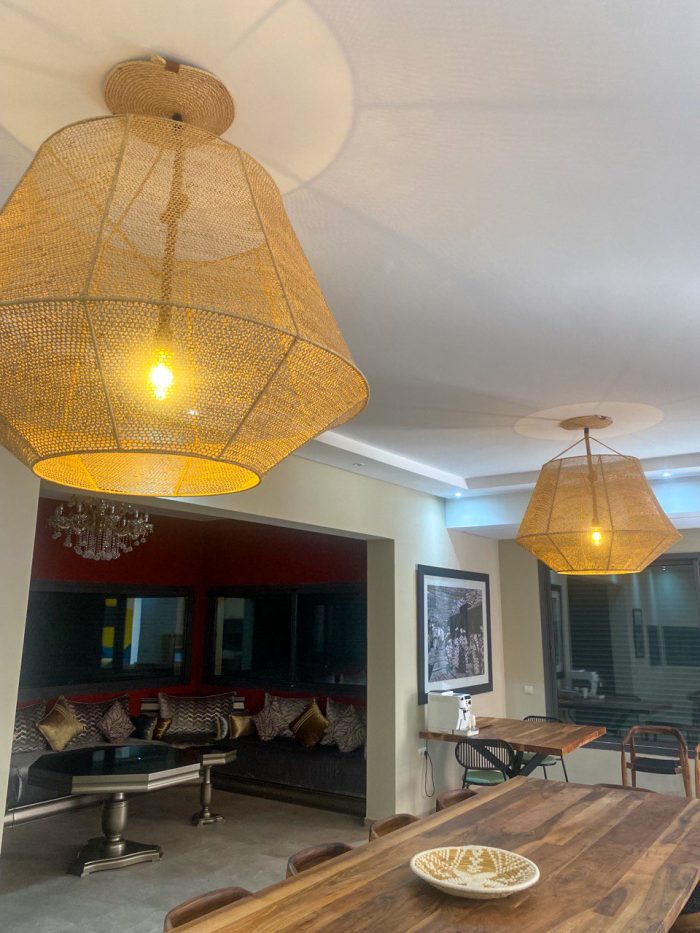 Handmade raffia pendant light with wide flared woven shape