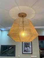 Handmade raffia pendant light with wide flared woven shape