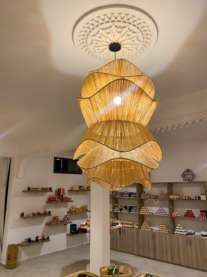 Spiral raffia pendant light with cascading handwoven layers
