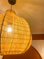 Sculptural raffia pendant light with rounded handmade Moroccan woven shade