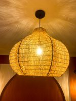 Sculptural raffia pendant light with rounded handmade Moroccan woven shade