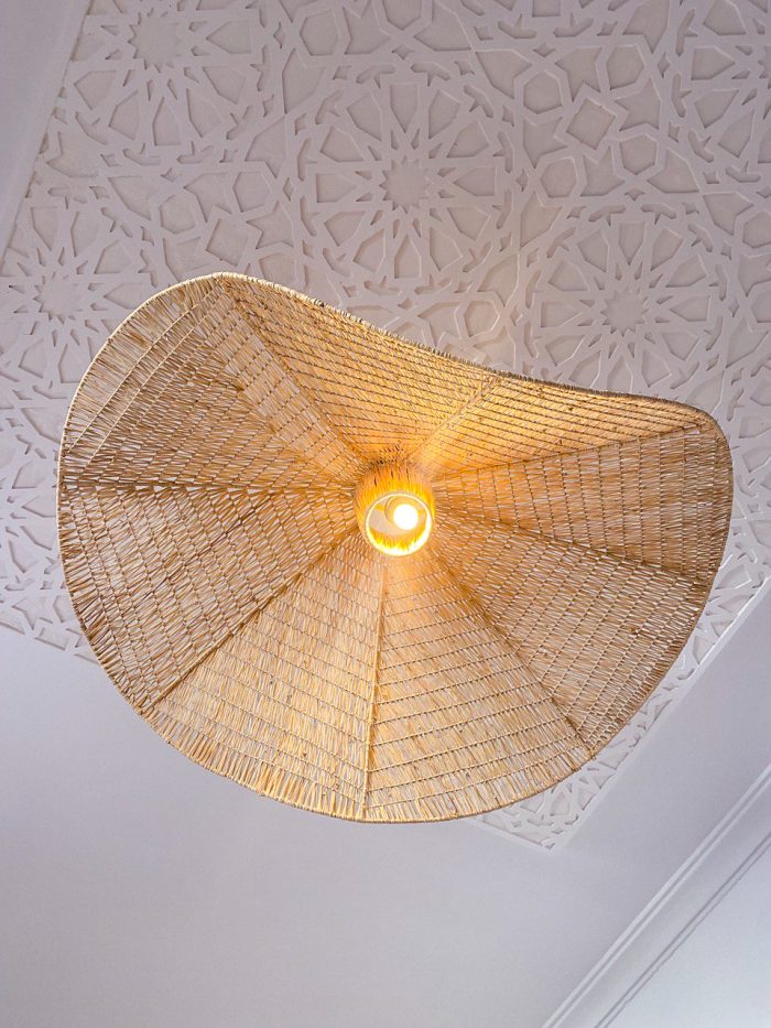 Handmade wavy raffia pendant light with sculptural woven dome shape