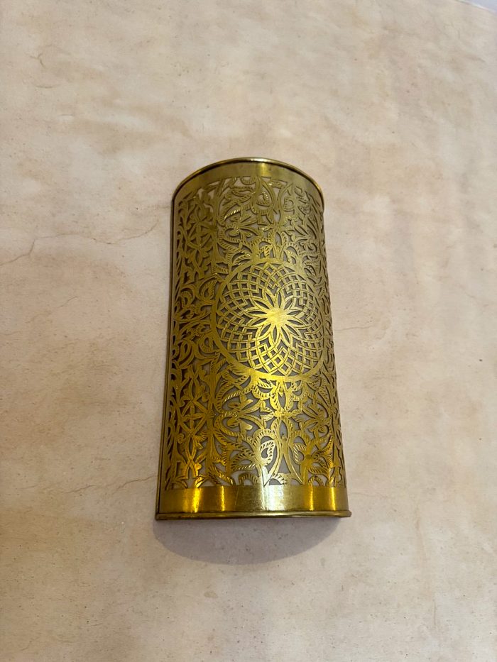 Handmade Moroccan brass wall sconce crafted from solid brass with intricate pierced detailing and warm up-and-down decorative illumination.