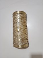 Handmade Moroccan rosette brass wall sconce with pierced floral pattern and warm ambient lighting.