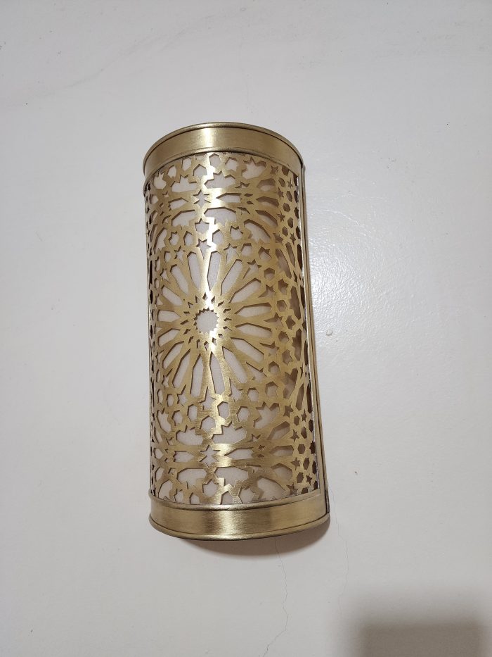 Handmade Moroccan rosette brass wall sconce with pierced floral pattern and warm ambient lighting.