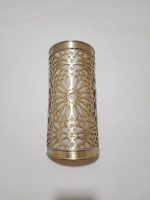 Handmade Moroccan rosette brass wall sconce with pierced floral pattern and warm ambient lighting.