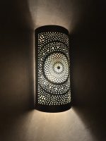 Handmade radiant rosette brass wall sconce with central geometric floral medallion and pierced decorative pattern.