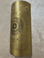 Handmade radiant rosette brass wall sconce with central geometric floral medallion and pierced decorative pattern.