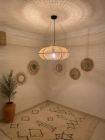 Sculptural Raffia Pendant Light handmade from natural woven raffia with a structured metal frame.