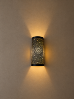 Handmade sunburst brass wall sconce with circular pierced medallion and warm up and down ambient lighting.