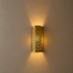 Handmade sunburst brass wall sconce with circular pierced medallion and warm up and down ambient lighting.