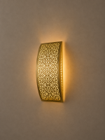 Handmade lattice filigree brass wall sconce with bowed rectangular shape, ornamental openwork and warm ambient lighting.