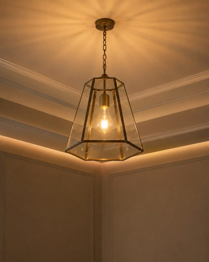 Handmade trapezoid glass pendant light with clear panels and geometric metal frame hanging from ceiling.