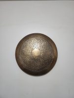 Handmade round brass wall light with floral rosette openwork, solid center medallion and warm glowing halo.