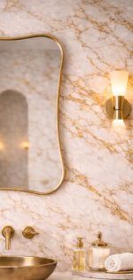 Handmade wavy rectangle brass wall mirror with organic curved edges and solid brass frame above bathroom vanity.
