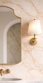 Crown Top Brass Mirror above wood bathroom vanity with brass fixtures