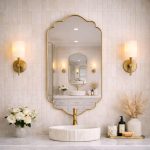 Moroccan lobed brass mirror with decorative curved frame above bathroom vanity