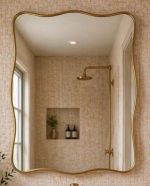 Handmade Wavy Brass Bathroom Mirror with curved edges in Moroccan bathroom interior