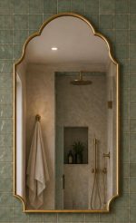 Handmade triple arch brass wall mirror with solid brass frame and clear glass displayed above a bathroom vanity.