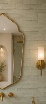 Handmade pointed arch brass vanity mirror with clear glass, solid brass frame and symmetrical pointed silhouette above a bathroom vanity.