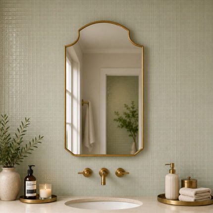 Crown Top Brass Mirror above wood bathroom vanity with brass fixtures